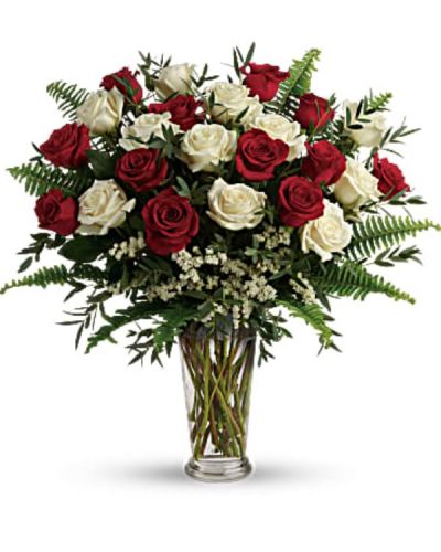 <div id="mark-1" class="m-pdp-tabs-marketing-description">A truly breathtaking tribute to your love, this romantic arrangement bursts with a dozen and a half red and white roses, nestled among delicate greens.</div>
<div id="desc-1">
<ul>
<li>This bouquet includes red roses, white roses, white sinuata statice, parvifolia eucalyptus, and sword fern.</li>
<li>Delivered in a clear romanesque vase.</li>
</ul>
</div>