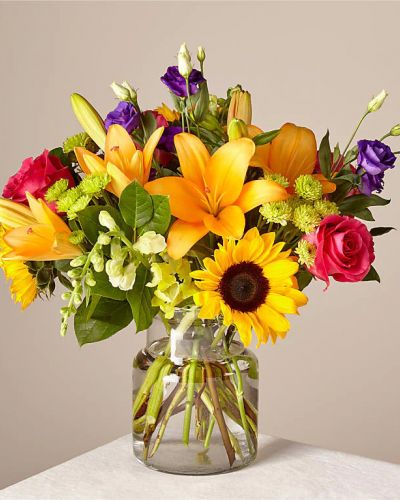 <p>Make this day their best day. Our local florist handcraft a colorful array of flowers in a clear glass vase to create a celebration in bloom. Perfect to give for a special reason or to simply share a smile.</p>