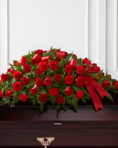 <p>The FTD® Dearly Departed™ Casket Spray bursts with the love and passion that the deceased had for their life and loved ones. Rich red roses and carnations are gorgeously arranged amongst lush greens and accented with a red satin ribbon to create the ideal adornment for their casket at their final farewell service.</p>