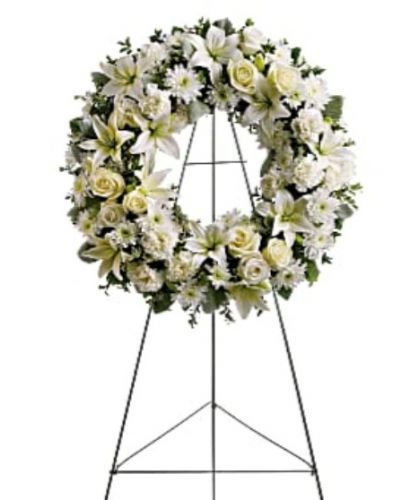 <div id="mark-1" class="m-pdp-tabs-marketing-description">Fragrant and ethereal white blossoms set among a ring of soothing greens form a classic wreath certain to evoke the pure heart and gentle spirit of a loved one – and offer consolation during a funeral or wake.</div>
<div id="desc-1">
<ul>
<li>Delivered on an easel, a standing wreath comprising fresh flowers such as white roses, asiatic lilies, carnations and chrysanthemums, as well as greens including salal, oregonia and dusty miller.</li>
</ul>
</div>
