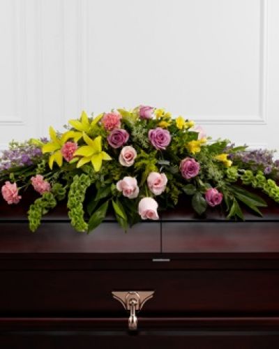 <p>The FTD® Forever Beloved™ Casket Spray beautifully illuminates the atmosphere of their final farewell service. Lavender roses, pink roses, lavender larkspur, pink carnations, Bells of Ireland, yellow Asiatic lilies, yellow freesia, solidago and lush greens are arranged to create an extravagant display of floral beauty that offers comfort and peace to the friends and family of the deceased.</p>