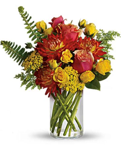 <p>As warm and inviting as falling asleep in the sun at the seaside. Bright summer flowers including orange dahlias, yellow spray roses and two-tone orange roses get a tropical twist with the addition of sword fern. Send summer someone’s way today!<br />
Orange bi-color roses, yellow spray roses and orange dahlias are mixed with yarrow, solidago, sword fern and salal in a simple cylinder vase.</p>