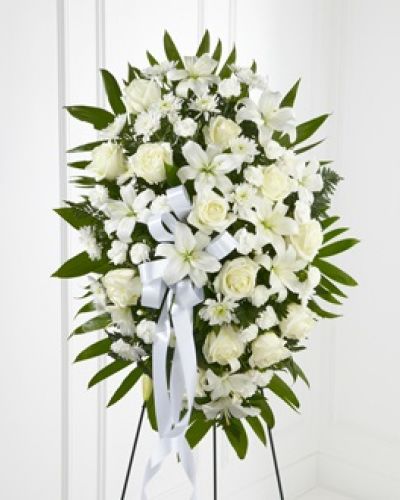 <p>The FTD® Exquisite Tribute™ Standing Spray is an elegant display of sweet serenity. White roses, Asiatic lilies, chrysanthemums and mini carnations are artfully arranged amongst emerald palm fronds and lush greens. Accented by white satin ribbon and standing on a wire easel, this standing spray is an outstanding way to honor the life of your loved one.</p>