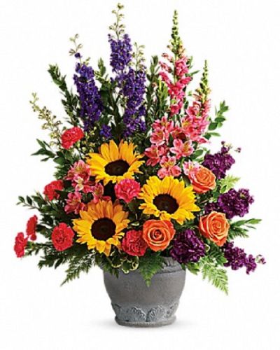 <div class="m-pdp-tabs-description">
<div id="mark-1" class="m-pdp-tabs-marketing-description">A colorful reminder that brighter days are ahead, this uplifting arrangement of sunflowers and roses in an elegant large antiqued pot brings joy and hope.</div>
</div>
<p id="arrngDescp">This bright arrangement includes orange roses, pink alstroemeria, hot pink carnations, yellow sunflowers, purple larkspur, purple stock, hot pink snapdragons, myrtle, variegated pittosporum, and leatherleaf fern.</p>