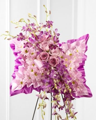 <p>The FTD® Simply Restful™ Floral Pillow is a gorgeous display of soft serenity. Lavender daisies, purple dendrobium orchids and lavender roses are beautifully arranged against a bed of purple and lavender satin to create a stunning presentation. Displayed on a wire easel, this arrangement bursts with grace and elegance to honor the life of the deceased.</p>