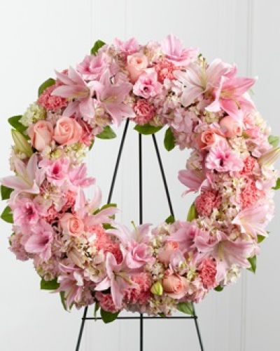 <p>The FTD® Loving Remembrance™ Wreath is a blushing display of grace and beauty to honor the life of the deceased at their final tribute. Pink roses, Oriental lilies, gladiolus, hydrangea and carnations are brought together with lush greens to form the shape of a wreath, offering warmth and comfort with its sweetly sophisticated elegance. Displayed on a wire easel.</p>