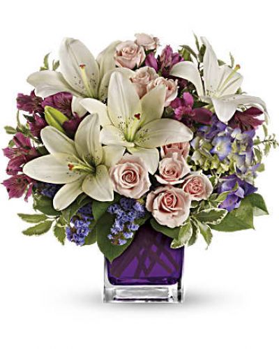 <p>Va-va-bloom! This grand array of purple hydrangea, light pink spray roses and white asiatic lilies is presented in our violet cube.</p>