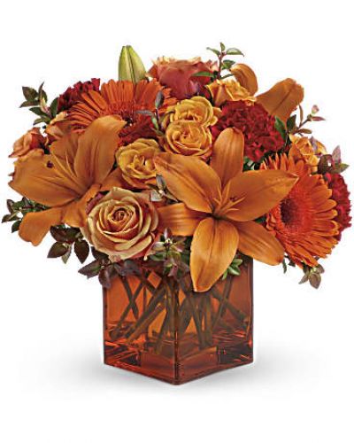 <div id="mark-3" class="m-pdp-tabs-marketing-description">Celebrate the wonder of a new day with warm, golden flowers. A modern orange glass vase is the foundation of this stunning, sun-bright bouquet that energizes any occasion.</div>
<p><del> </del></p>
<p>&nbsp;</p>
<ul>
<li>Orange gerbera daisies, orange roses and red mini carnations are accented with a spray of red huckleberry in an orange cube</li>
</ul>
<div id="desc-3">
<ul>
<li>vase.</li>
</ul>
</div>
<p>&nbsp;</p>
<ul>
<li></li>
</ul>
<p>&nbsp;</p>