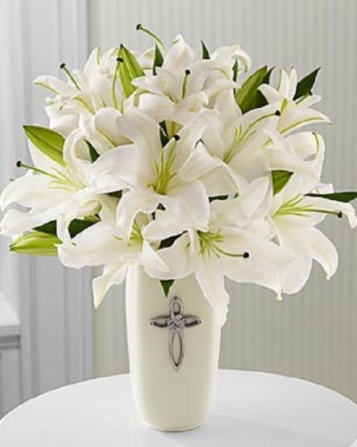 <p>This striking display of pure white lilies will send your heartfelt expressions when words just aren't enough. Arranged in a white ceramic vase and enhanced by a cross, this arrangement is perfect for celebrations, confirmations, sympathy, weddings, or a special anniversary.This is an all-around arrangement.</p>