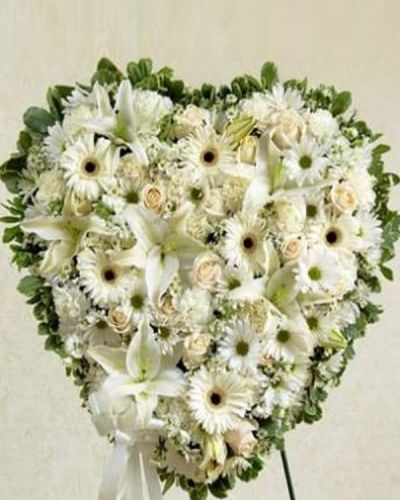 <p>This solid heart standing spray makes a beautiful statement about your heartfelt compassion and sympathy. White flowers such as roses, lilies, Gerbera daisies, carnations and more form the solid heart which is tied to a wire easel with satin ribbon. Traditionally sent directly to the funeral home by family, friends or business associates.</p>