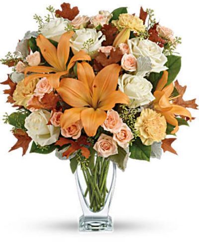 <p>Capture the natural beauty of autumn with this stunning arrangement of lilies and roses in an elegant glass vase, sure to brighten any fall day.<br />
This beautiful arrangement features white and peach roses, peach asiatic lilies and peach carnations and is finished with dusty miller, seeded eucalyptus, brown oak leaves and lemon leaf.</p>